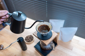 Hand drip coffee, Barista making drip coffee with mockup blank package coffee Alternative ways of brewing Coffee shop concept
