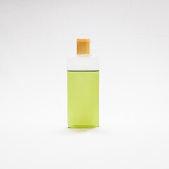 bottle of natural green oil in a white background