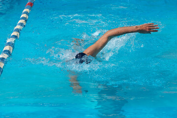 an adult, former swimmer, trains in a public swimming pool