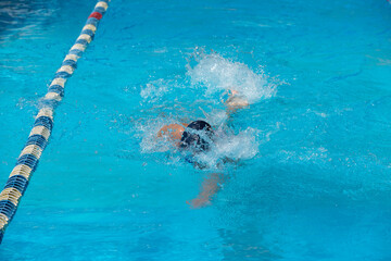 an adult, former swimmer, trains in a public swimming pool