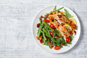 grilled salmon fillets with lemon, bacon,vegetables