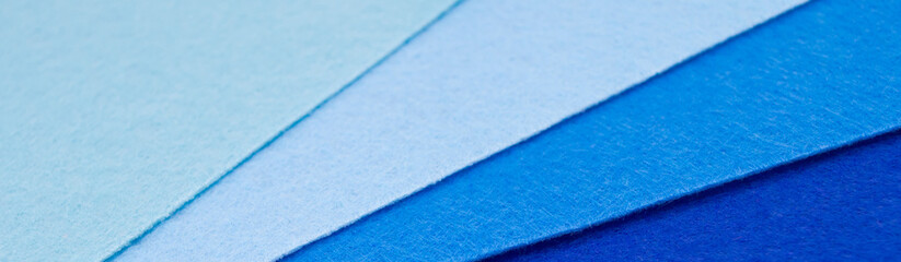 Banner with pieces of felt of different shades of blue from dark to very light. Blue spectrum. Copy...