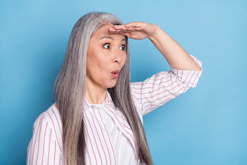 Profile side photo of excited woman amazed shocked surprised look ahead isolated over blue color background