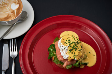 hot sandwich with bacon and mazzarella cheese and a cup of coffee