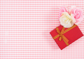 gift box with red isolated on Plaid background. Holiday decoration for Mother's Day or Women's Day.