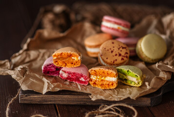 Macarons cakes lie in a stack on the background