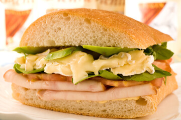 Sandwich with avocado, ham, tomato, lettuce and camembert Cheese