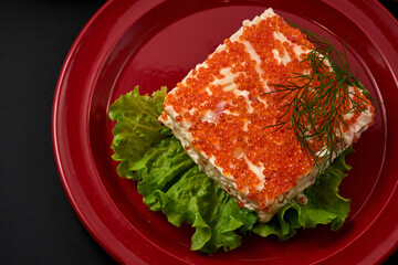 New Year's salad decorated with red caviar