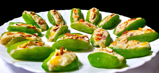 Pointed gourd sweets isolated in black background.