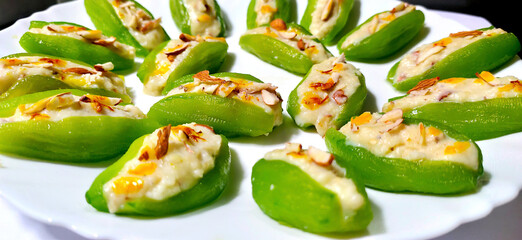 Pointed gourd sweets isolated in black background.