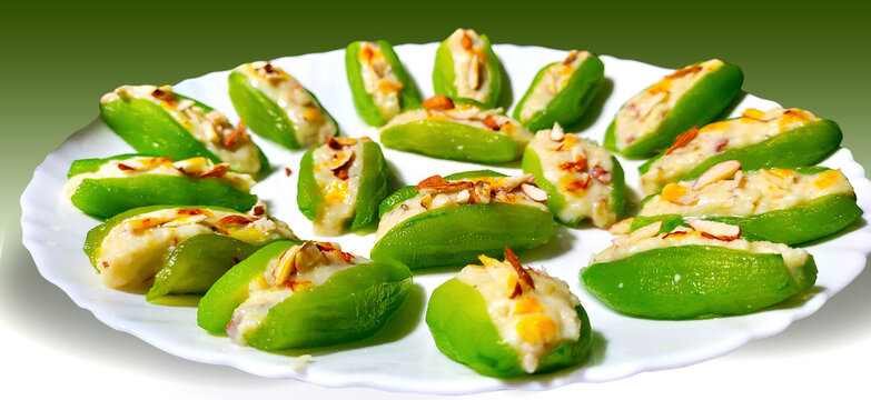 Pointed gourd sweets isolated in black background.