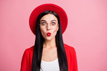 Fototapeta premium Photo portrait of flirty gorgeous woman sending air kiss isolated on pastel pink colored background