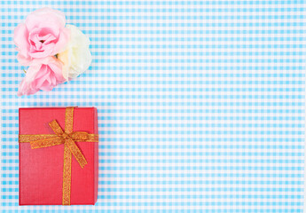 gift box with red isolated on Plaid background. Holiday decoration for Mother's Day or Women's Day.