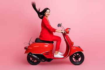 Fototapeta na wymiar Full body profile side photo of young attractive woman happy positive smile driving red motorbike isolated over pink color background