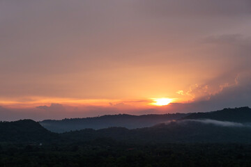 Seeing Sunset in cloudy day and the fog in the mountain.