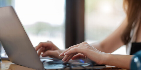 Close up of woman or accountant hand holding pencil working on calculator to calculate financial data report, accountancy document and laptop computer at office, business concept