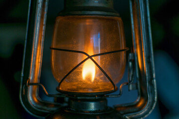 Vintage kerosene lamp with fire inside and glass bulb