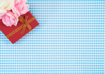gift box with red isolated on Plaid background. Holiday decoration for Mother's Day or Women's Day.