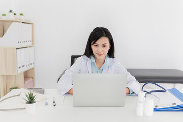asian female doctor search information and typing report with laptop, medical knowledge technology in hospital
