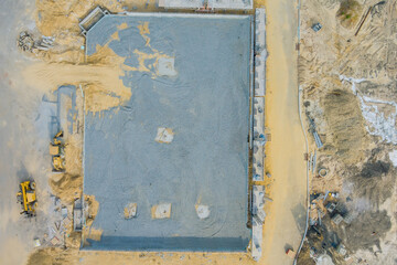 Aerial view on the construction site of mounting concrete brick walls