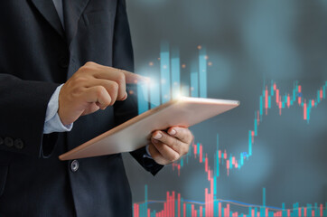 Businessman holding tablet and graph. Financial investment business and funds or stocks market. Digital marketing networking connection on virtual screen, Business technology concept