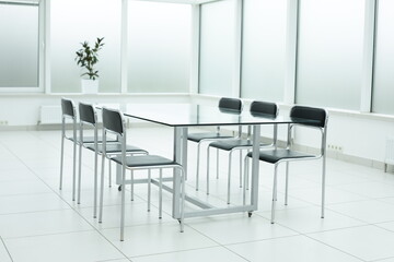 Black chairs and glass table in office space