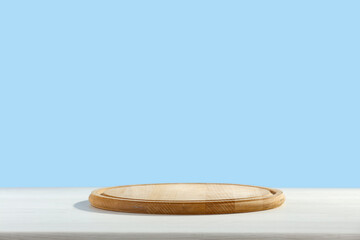 Wooden desk of free space and blue wall background 