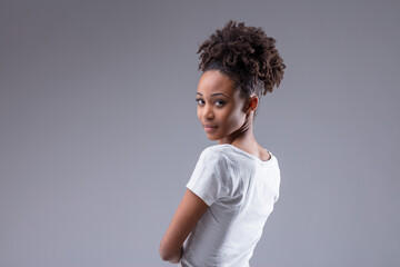 Attractive slim young Black woman looking back over shoulder
