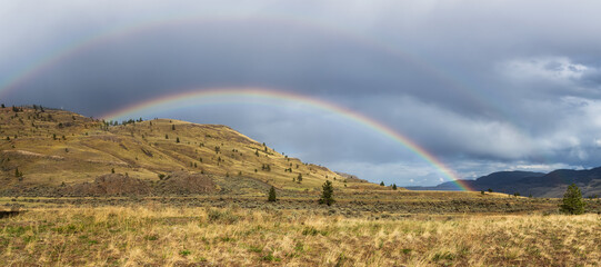 Triple Rainbow Weather Phenomenon. Panoramic View of Desert Mountain Canadian Nature Landscape. Stormy and Rainy. Taken in Savona near Kamloops, British Columbia, Canada.