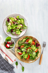 Summer healthy vegetables salad with cucumber, radish, micro greens and tomato. Summer healthy vegetable salad.