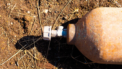 A close up image of an old rusted propane cylinder shut off valve.