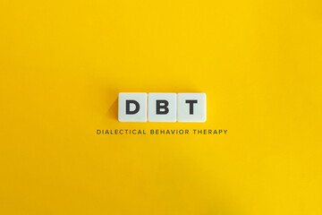 Dialectical behavior therapy (DBT) banner and concept. Block letters on bright orange background....