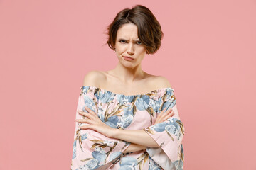 Young shrewd frowning sad angry indignant woman 20s with short hairdo wearing trendy blouse hold...