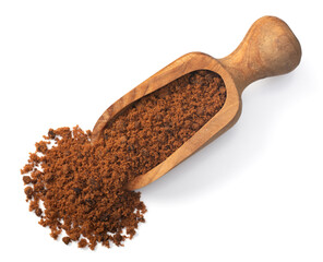 brown granulated sugar in the wooden scoop, isolated on white background, top view