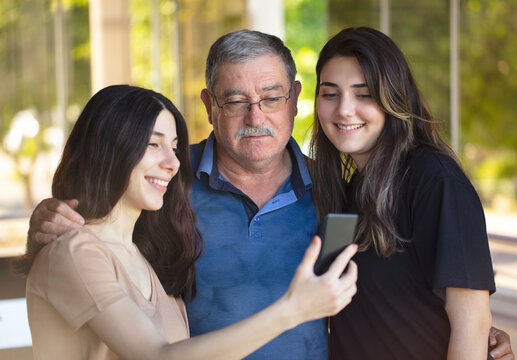 father and daughters. happy fathers day concept. happy family selfie with phone.
