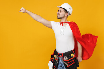 Powerful employee handyman man in superhero suit helmet hardhat makes fly gesture isolated on...