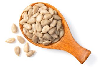 peeled sunflower seeds in the wooden spoon, isolated on white background, top view