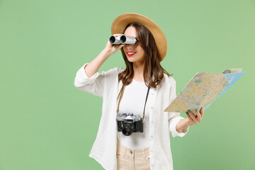 Traveler smiling exploring tourist woman in casual clothes hat hold paper map look through...
