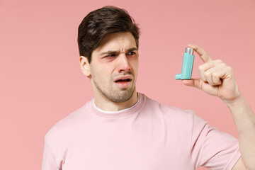 Sick ill allergic man has red watery eyes runny stuffy sore nose suffer from allergy trigger...