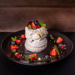 Meringue dessert with sweet syrup and cream