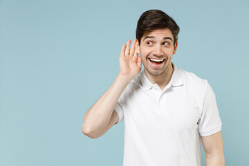 Young curious nosy unshaven man 20s wearing white casual basic t-shirt try to hear you overhear...