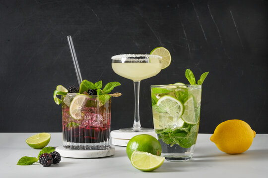 Classic And Blackberry Mojito, Margarita Cocktail With Lime On Black Background. Three Summer Freshness Beverage For Festive Party. Summer Holiday Mocktail.