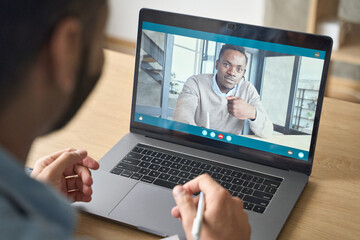 Fototapeta na wymiar Young indian confident businessman talking to male black man potential employee hiring for job. Virtual video call between employer entrepreneur and manager worker. Remote recruitment work concept.