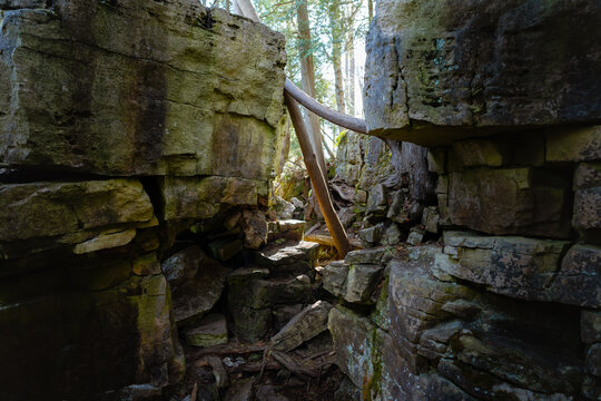 A narrow chasm separates two large sections of limestone