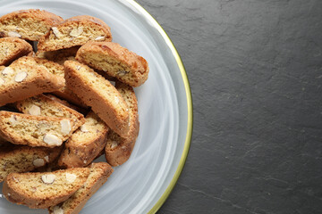Traditional Italian almond biscuits (Cantucci) on grey table, top view. Space for text