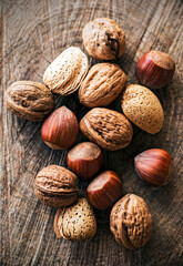 Varied nuts on wooden trunk