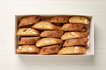 Traditional Italian almond biscuits (Cantucci) on white wooden table, top view
