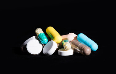 Heap of assorted pharmaceutical medicine pills in tablets and capsules different colors, medication