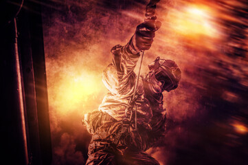Image of a military man attached with a rope to a helicopter. Battlefield style. The concept of war...