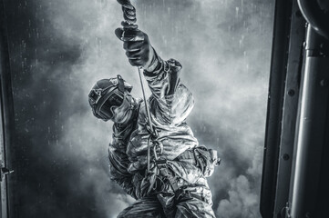 Soldier prepares to jump from a helicopter. The concept of computer games.